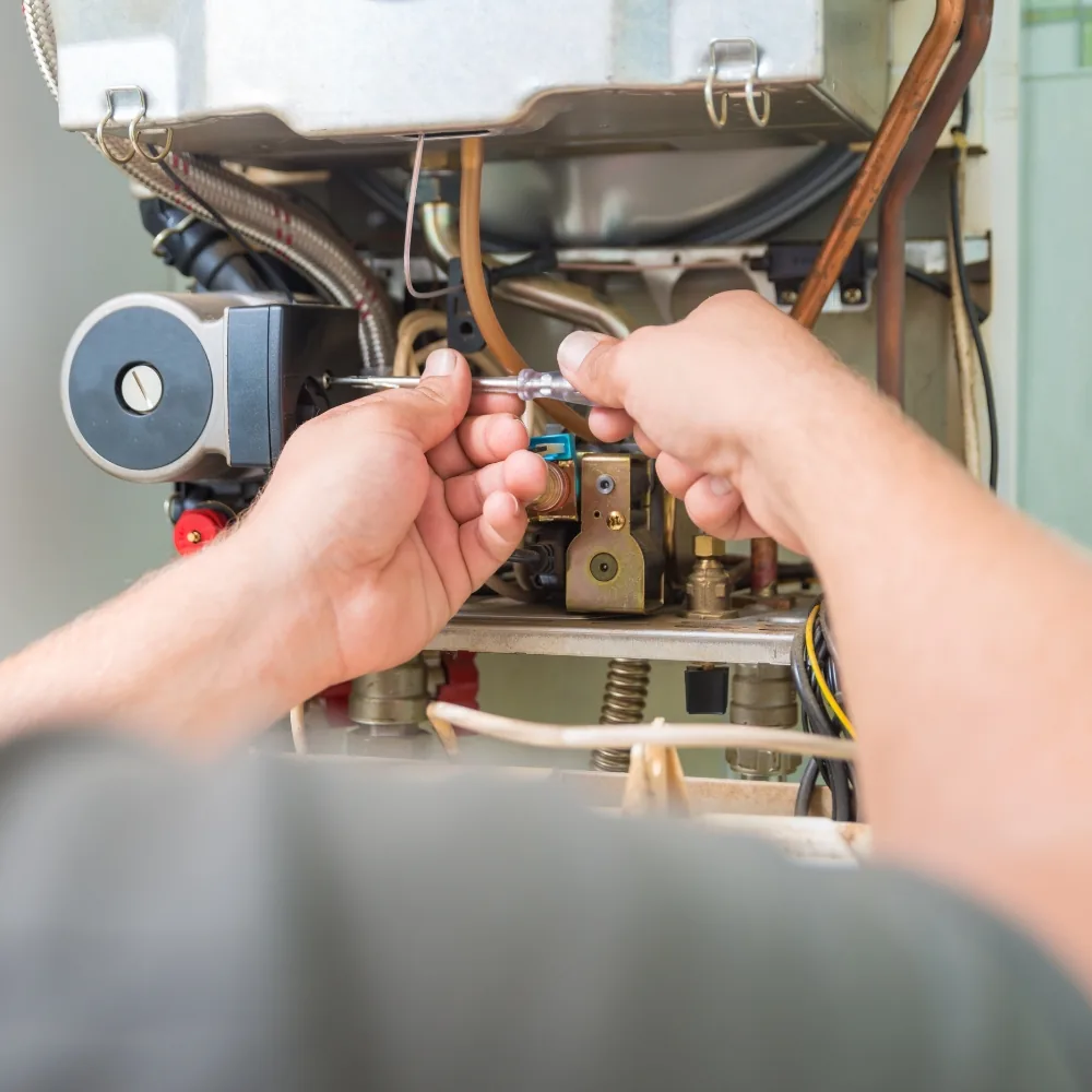 Furnace repair technician servicing a gas furnace in a Bellevue, WA home
